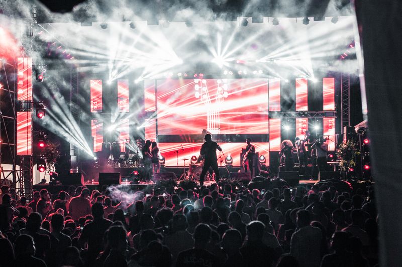 A live band performing under red stage lights