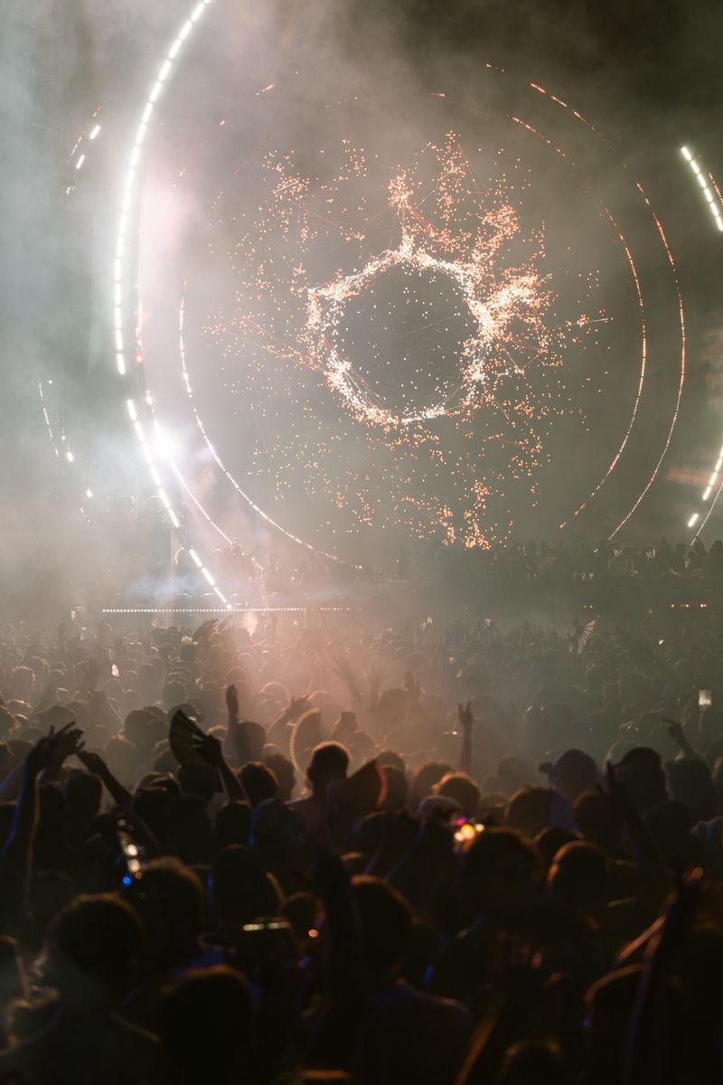 Fireworks bursting over a festival crowd